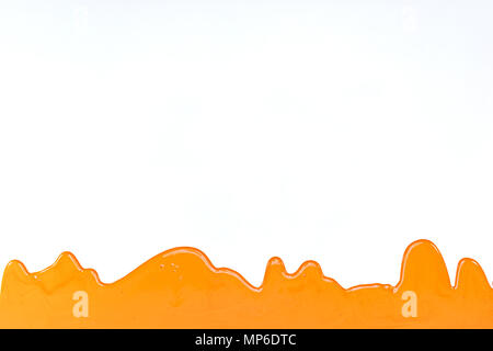 orange paint pouring on white background. renovation home concept Stock Photo