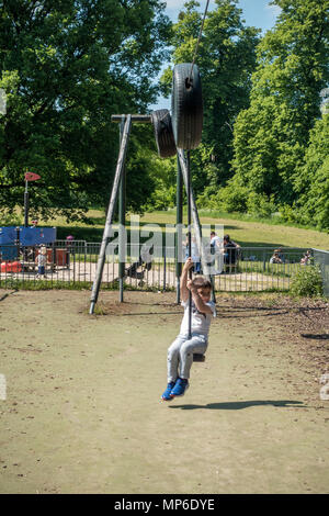 A young boy rides an aerial runway in Prospect Park in Reading, Berkshire, UK. Stock Photo