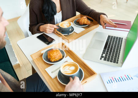 Business People Enjoying Coffee during Meeting Stock Photo