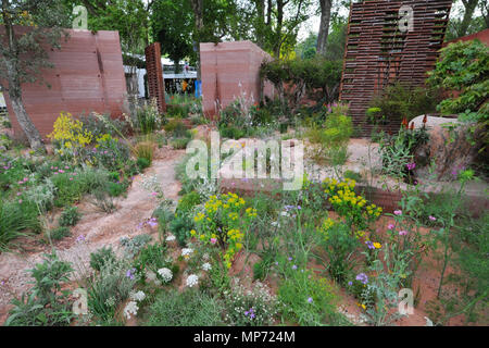 London, UK. 21st May 2018. The M&G Garden (designed by Sarah Price), one of the beautiful and elegant show gardens on display at the 2018 RHS Chelsea Flower Show which opened today in the 11-acre grounds of the Royal Hospital Chelsea, London, United Kingdom.  The garden is a romanticised haven set in a warm, sunny climate. It expands on a simple, timeless idea that three core elements - a wall, trees and seating - can create an intimate, sheltered and beautiful oasis of calm. Credit: Michael Preston/Alamy Live News Stock Photo