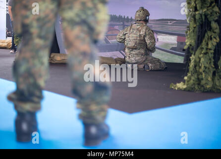Stuttgart, Germany. 15th May, 2018. 15 May 2018, Germany, Stuttgart: An extra using a simulation program by Holovis during the ITEC fair for military and weapons technology. Credit: Sebastian Gollnow/dpa/Alamy Live News Stock Photo