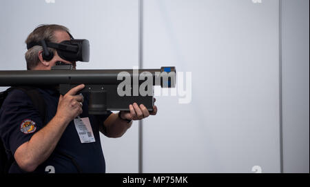 Stuttgart, Germany. 15th May, 2018. 15 May 2018, Germany, Stuttgart: A man using an Aegis rocket-launcher simulator during the ITEC fair for military and weapons technology. Credit: Sebastian Gollnow/dpa/Alamy Live News Stock Photo