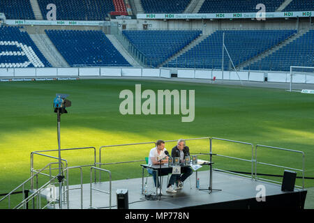 21 May 2018, Germany, Hannover, Soccer: Per Mertesacker (L), former player for the German soccer national team, sitting during his book's launch with Christian Stoll, Werder Bremen announcer, in the HDI Arena in Hannover. Mertesacker is presenting his autobiography 'Weltmeister ohne Talent' ('World Champion without talent') in Hannover. Photo: Peter Steffen/dpa Stock Photo