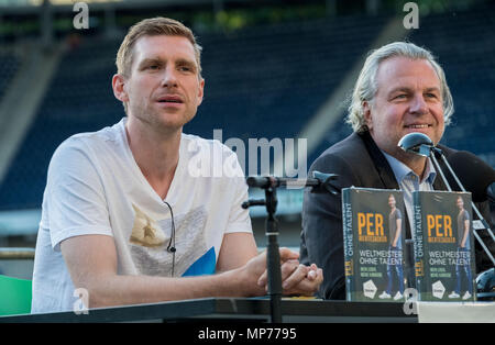 21 May 2018, Germany, Hannover, Soccer: Per Mertesacker (L), former player for the German soccer national team, sitting during his book's launch with Christian Stoll, Werder Bremen announcer, in the HDI Arena in Hannover. Mertesacker is presenting his autobiography 'Weltmeister ohne Talent' ('World Champion without talent') in Hannover. Photo: Peter Steffen/dpa Stock Photo