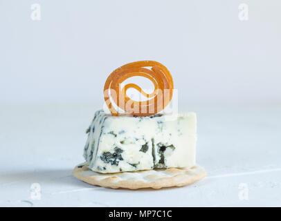 Blue cheese on cracker with candied peach roll decoration Stock Photo