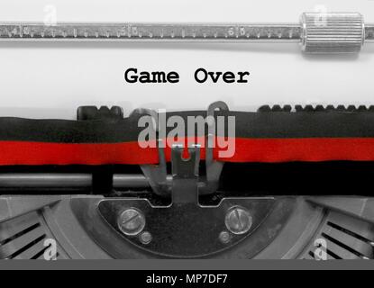 Game Over text written by an old typewriter on white sheet Stock Photo