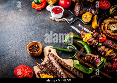 Assortment various barbecue food grill meat, bbq party fest - shish kebab, sausages, grilled meat fillet, fresh vegetables, sauces, spices, dark rusty Stock Photo