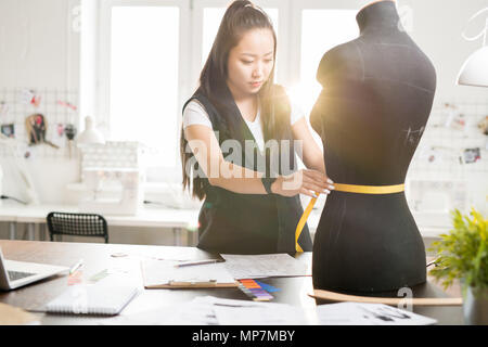 Asian Fashion Designer Working in Atelier Stock Photo