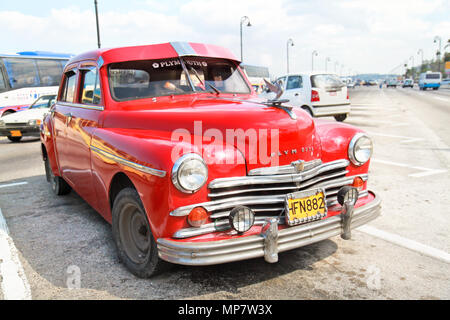 HAVANA-FEBRUARY 4:Classic red Plymouth on February 4, 2010,Havana.Under current law that the government plans to change before 2012,Cubans can only bu Stock Photo