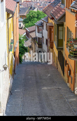 Old medieval narrow stone paved street in Buda district of Budapest on a sunny day in summer. Shot at Gul Baba street. Stock Photo