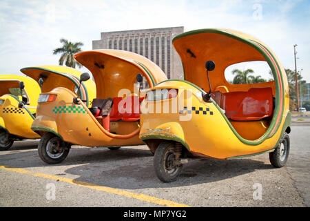 HAVANA-FEBRUARY 2: Yellow coco taxi on Revolucion plaza on February 2, 2010 in Havana, Cuba Stock Photo