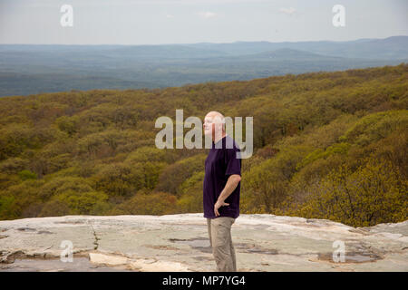 Senior male hiker standing on Sam's Point Overlook, Ulster County, New York. Stock Photo