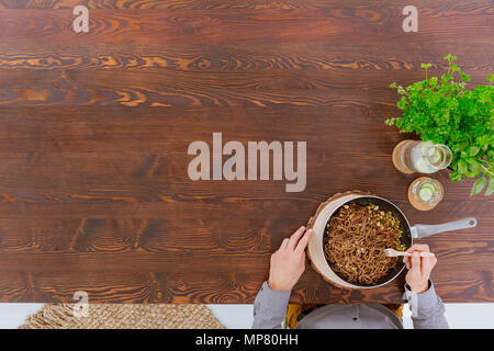 Man eating whole wheat spaghetti with sprouts, top view Stock Photo