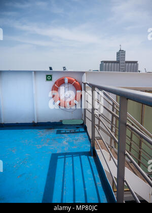 Life buoy and part of a ferry in Barcelona Port under on a sunny day Stock Photo