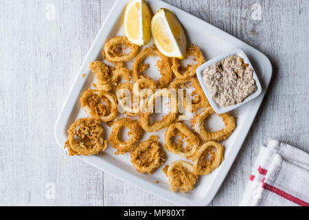 Fried Crispy Calamari Squid Rings with Tartar Sauce and Lemon. SeaFood Concept. Stock Photo