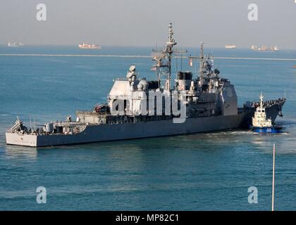 A tugboat guides the U.S. Navy Ticonderoga-class guided-missile cruiser USS Cape St. George out of port January 10, 2012 in Laem Chabang, Thailand.   (photo by Adam Randolph via Planetpix) Stock Photo