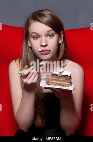 Cheerful woman eating pie Stock Photo