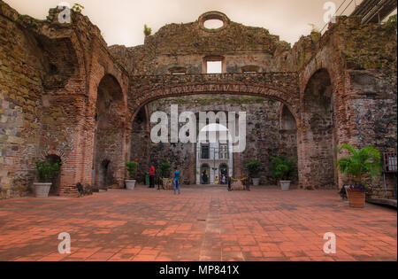 Unidentified people walking inside of ruins of the Jesuits Convent. Part of Casco Antiguo's UNESCO patrimony in old Panama city, which was destroyed by a fire in the XVIII century Stock Photo