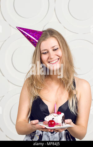 beautiful caucasian girl blowing candles on her cake Stock Photo