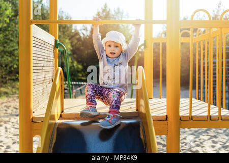 child on slider at playground Stock Photo