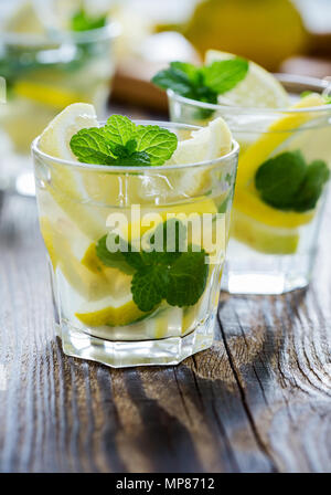 Fresh homemade lemonade with lemon slices and fresh mint on wooden table Stock Photo