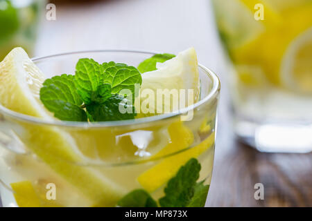 Fresh homemade lemonade with lemon slices and fresh mint on wooden table Stock Photo