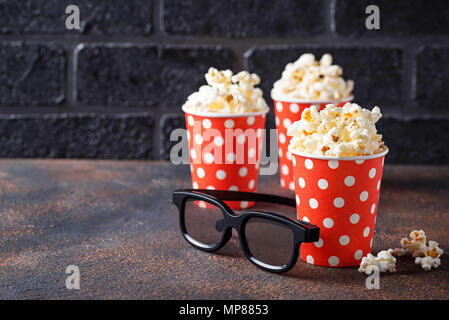 Popcorn with 3d glasses on dark background Stock Photo