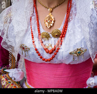 CAGLIARI, Italy - May 1, 2018: The famous Festival of Sant Efisio in Sardinia. Close up of wearing necklace during the religious procession Stock Photo
