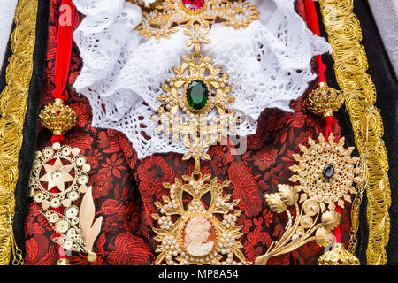 CAGLIARI, Italy - May 1, 2018: The famous Festival of Sant Efisio in Sardinia. Close up of wearing necklace during the religious procession Stock Photo
