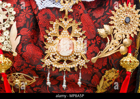 CAGLIARI, Italy - May 1, 2018: The famous Festival of Sant Efisio in Sardinia. Close up of wearing necklace during the religious procession Stock Photo