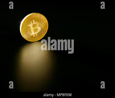 Bitcoin BTC coin reflection on the black soil background Stock Photo