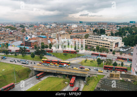 aerial view of early morning rush hour traffic featuring numerous taxis and articulated Transmilenio buses in Colombia's capital, Bogotá Stock Photo
