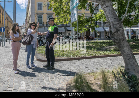 Lisbon, Portugal, May 6, 2018: A couple of tourists are asking a policeman for directions. Stock Photo