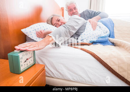 stop the alarm and no wake up stay and rest on the bed for senior couple people at home. indoor lazy morning concept life day with window light Stock Photo