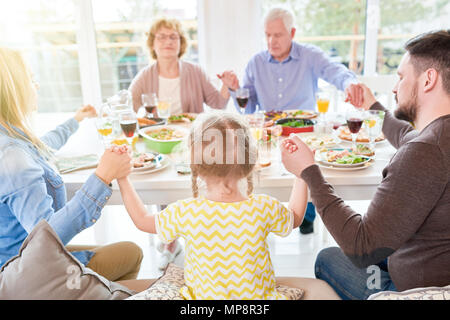 Family Praying at Family Dinner Stock Photo