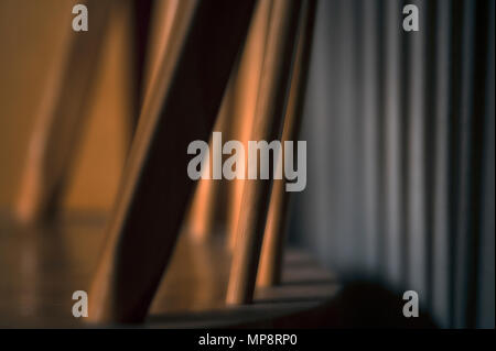 Chair abstract indoors close-up of shadows and highlights on wall with strong contrast Stock Photo