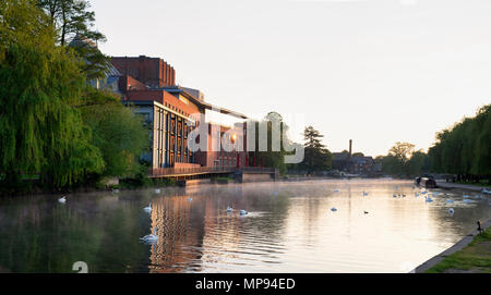 Royal Shakespeare Theatre reflecting in the river avon at sunrise. Stratford Upon Avon, Warwickshire, England Stock Photo