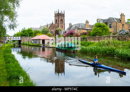 View of the Union Canal with woman in canoe at Polwarth in Edinburgh, Scotland, United Kingdom Stock Photo