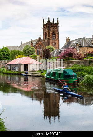 View of the Union Canal with woman in canoe at Polwarth in Edinburgh, Scotland, United Kingdom Stock Photo