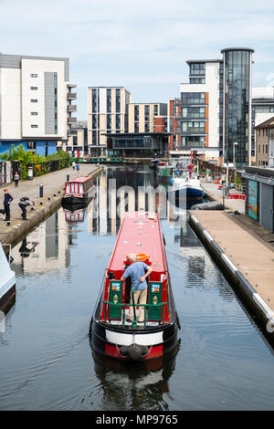 View of Union Canal at Lochrin Basin with narrow boat sailing to mooring at Fountainbridge in Edinburgh, Scotland, United Kingdom, UK Stock Photo