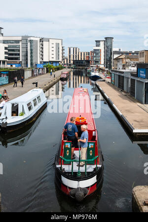 View of Union Canal at Lochrin Basin with narrow boat sailing to mooring at Fountainbridge in Edinburgh, Scotland, United Kingdom, UK Stock Photo