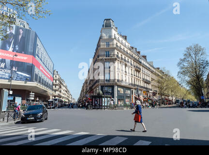 Paris, France - April 17, 2018: Woman crossing the street near the Galeries Lafaiette Stock Photo