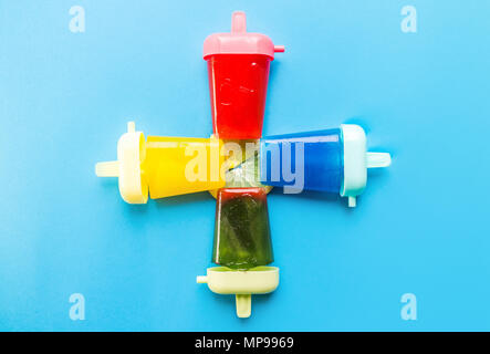 Homemade popsicles isolated on blue background Stock Photo