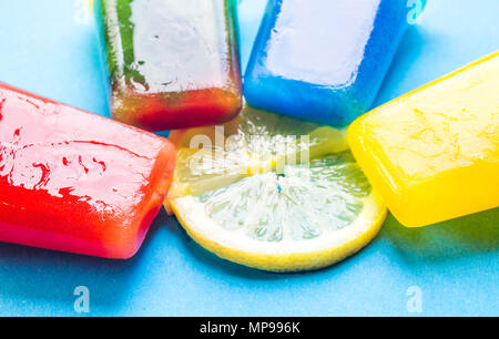 Homemade popsicles isolated on blue and yellow background Stock Photo