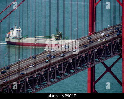 Ship sailing under April 25 bridge, Lisbon, Portugal Stock Photo