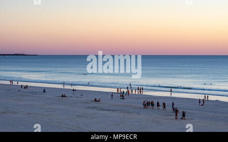 People enjoying a swim as the sun sets over Cable Beach, Broome, WA, Australia. Stock Photo