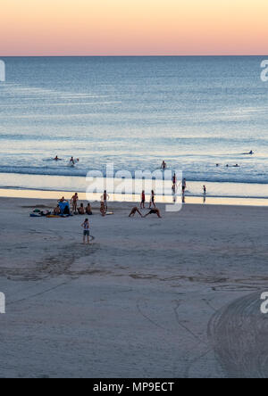 People enjoying a swim as the sun sets over Cable Beach, Broome, WA, Australia. Stock Photo