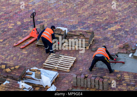 Workers pave sidewalk Stock Photo