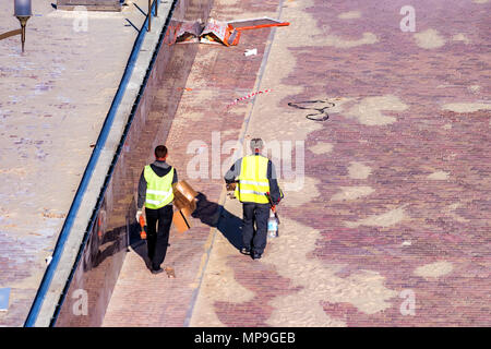 Workers pave sidewalk Stock Photo
