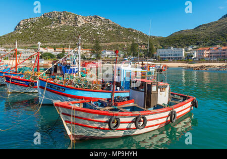 Fishing boats in the harbor of Kalk Bay with the Table Mountain range in the background near Cape Town, Western Cape Province, South Africa. Stock Photo